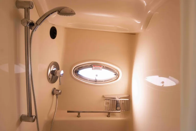  Yacht Photos Pics Shower area in 2008 Sea Ray 38 Sundancer yacht with oval window and chrome fixtures.