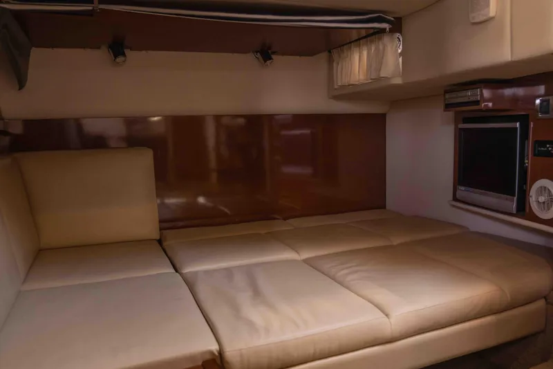  Yacht Photos Pics Interior cabin of 2008 Sea Ray 38 Sundancer with beige seating and entertainment system.