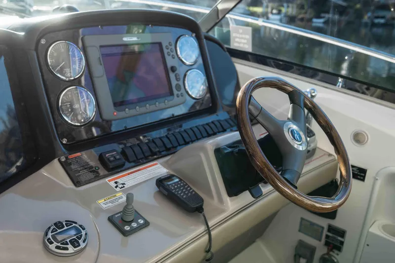  Yacht Photos Pics 2008 Sea Ray 38 Sundancer helm with wood steering wheel and navigation controls.