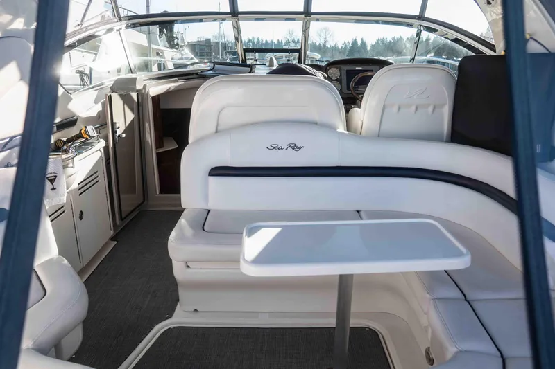  Yacht Photos Pics 2008 Sea Ray 38 Sundancer interior with white seating and table, showcasing luxury design.