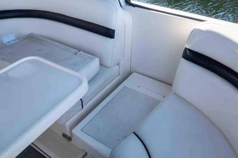  Yacht Photos Pics Interior seating of 2008 Sea Ray 38 Sundancer boat, featuring white upholstery and table.