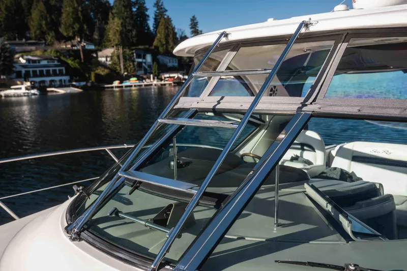  Yacht Photos Pics 2008 Sea Ray 38 Sundancer yacht with chrome ladder and scenic waterfront view.