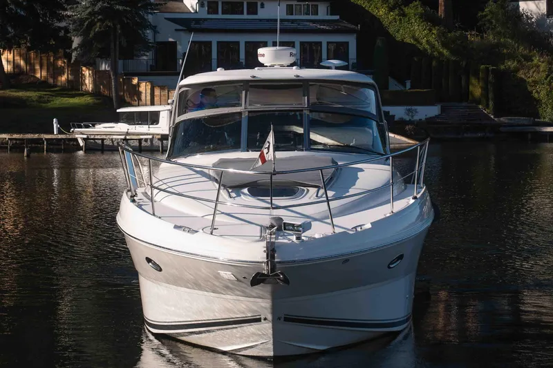  Yacht Photos Pics Front view of a 2008 Sea Ray 38 Sundancer yacht docked by a waterfront home.