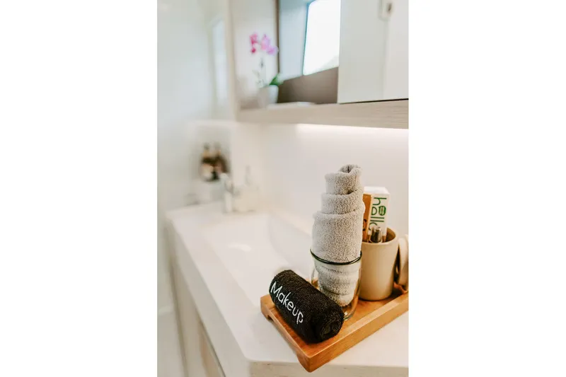 Wanderlust Yacht Photos Pics Luxurious bathroom setup in 2023 Lagoon 50 yacht with towels and toiletries.