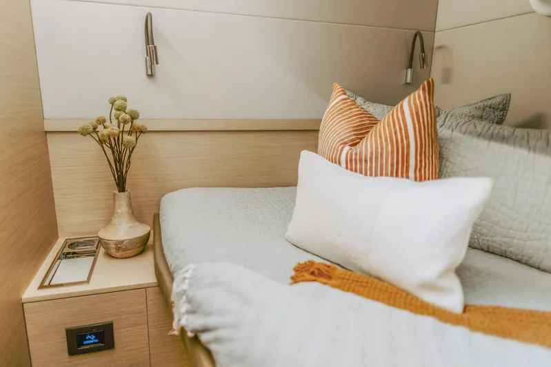 Wanderlust Yacht Photos Pics Luxurious 2023 Lagoon 50 yacht cabin with cozy bedding and elegant decor.