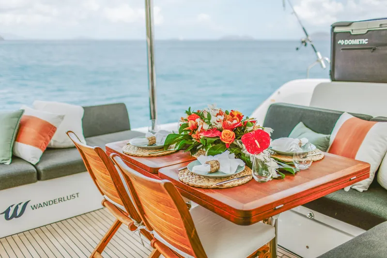 Wanderlust Yacht Photos Pics Luxurious dining setup on 2023 Lagoon 50 yacht with ocean view.