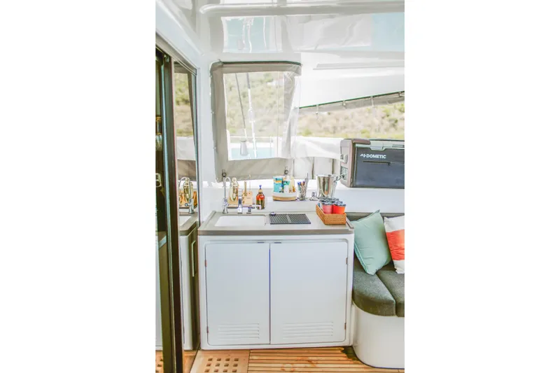 Wanderlust Yacht Photos Pics Interior of 2023 Lagoon 50 yacht with kitchenette and seating area.
