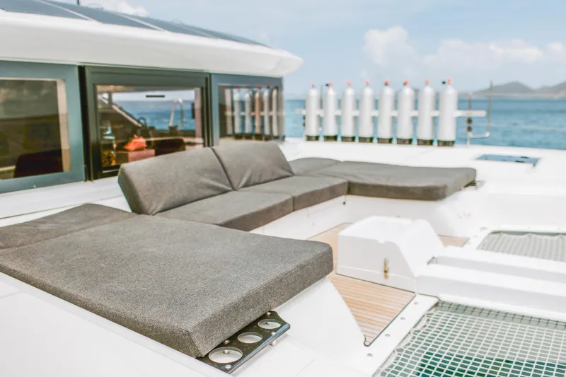 Wanderlust Yacht Photos Pics Luxurious 2023 Lagoon 50 yacht with comfortable outdoor seating and ocean view.