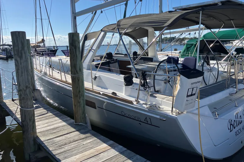  Yacht Photos Pics 2014 Beneteau Oceanis 281 sailboat docked at marina under clear blue sky.