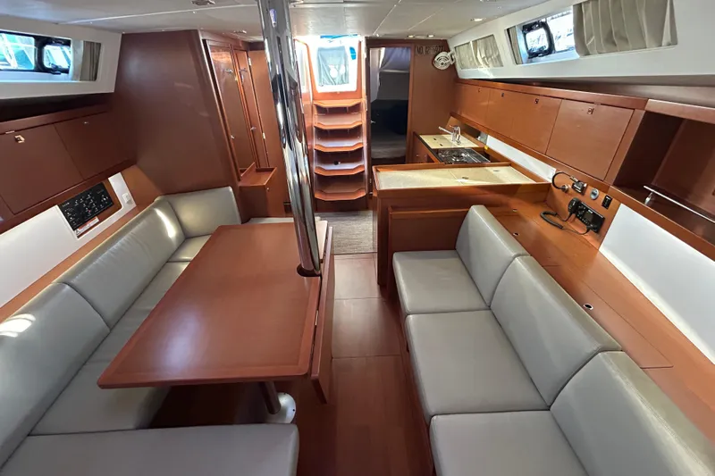  Yacht Photos Pics Interior of 2014 Beneteau Oceanis 41 yacht with modern wood finish and seating area.