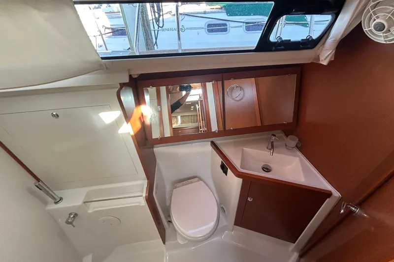  Yacht Photos Pics Bathroom interior of 2014 Beneteau Oceanis 41 yacht, featuring sink, toilet, and mirror.