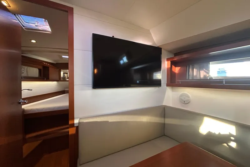  Yacht Photos Pics Interior of 2014 Beneteau Oceanis 41 yacht with TV and seating area.