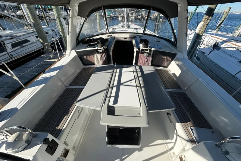  Yacht Photos Pics 2014 Beneteau Oceanis 41 sailboat cockpit with seating and table, docked at marina.