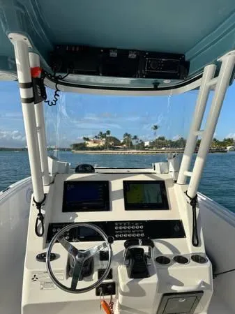  Yacht Photos Pics 2015 Edgewater 280CC boat dashboard with steering wheel and navigation screens.