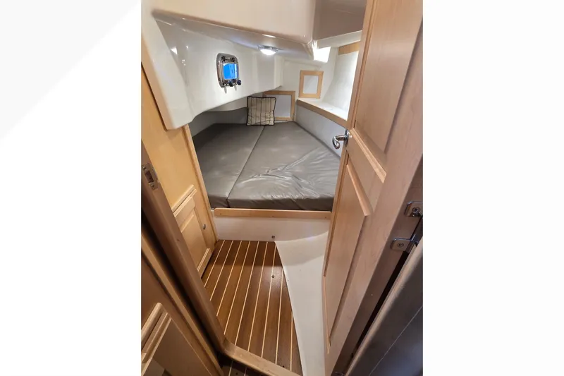 Irie Yacht Photos Pics 2018 Tartan 345 yacht interior cabin with wooden flooring and cozy bed.