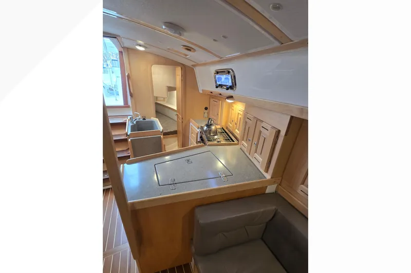 Irie Yacht Photos Pics Interior of 2018 Tartan 345 yacht featuring a compact kitchen and seating area.