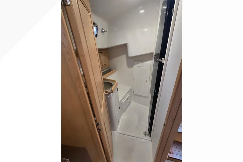 Irie Yacht Photos Pics 2018 Tartan 345 yacht interior bathroom with wooden cabinetry and compact design.