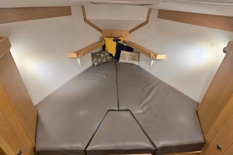 Irie Yacht Photos Pics Cozy cabin interior of 2018 Tartan 345 sailboat with cushions and decorative pillows.