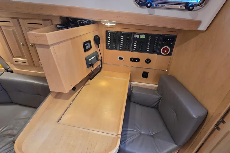 Irie Yacht Photos Pics 2018 Tartan 345 yacht interior with navigation panel and seating area.