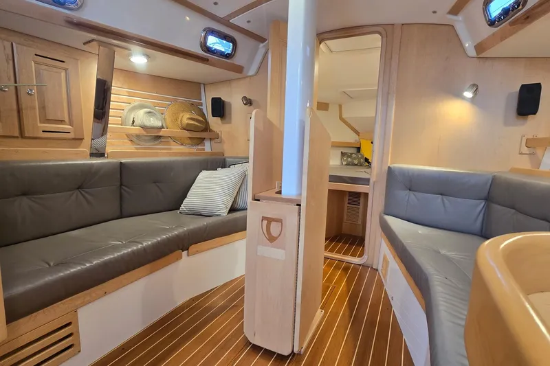 Irie Yacht Photos Pics Interior of 2018 Tartan 345 yacht with cozy seating and wooden finishes.