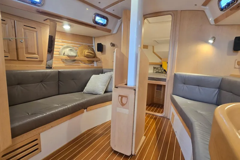 Irie Yacht Photos Pics Luxurious interior of 2018 Tartan 345 yacht with cozy seating and elegant wood finishes.
