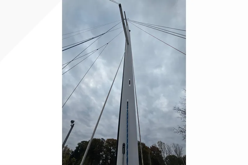 Irie Yacht Photos Pics Tall mast of 2018 Tartan 345 sailboat against cloudy sky.