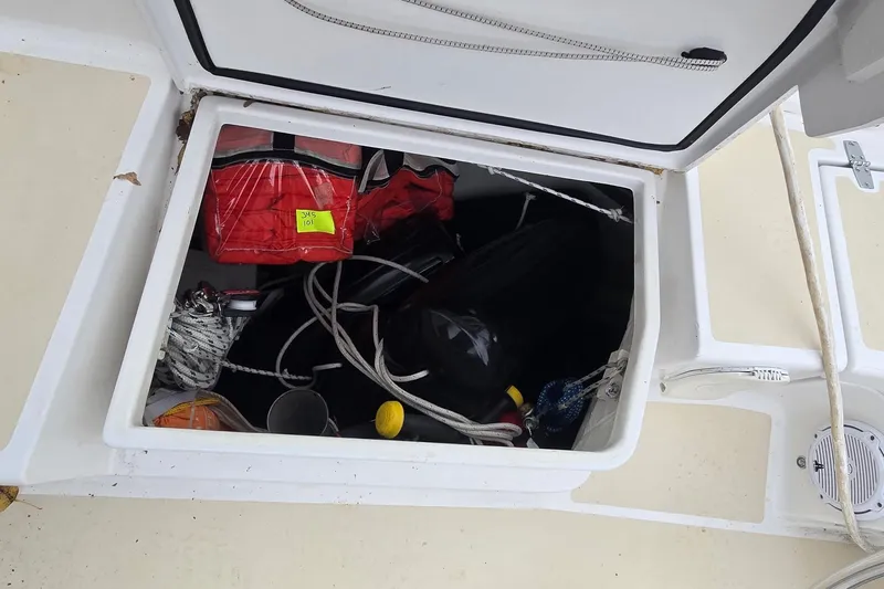 Irie Yacht Photos Pics Open storage compartment on a 2018 Tartan 345 sailboat, containing ropes and equipment.