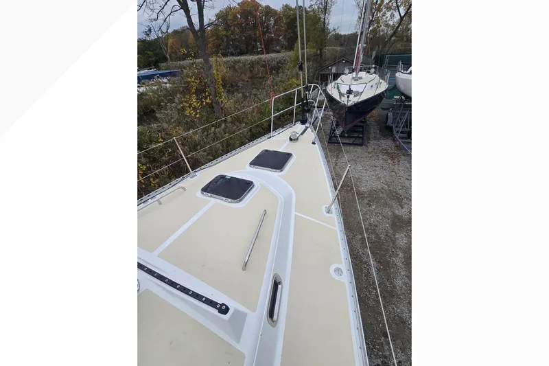 Irie Yacht Photos Pics 2018 Tartan 345 sailboat on land, showcasing deck and surrounding trees.