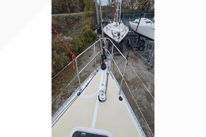 Irie Yacht Photos Pics Tartan 345 sailboat deck, 2018 model, docked with surrounding greenery and other boats.