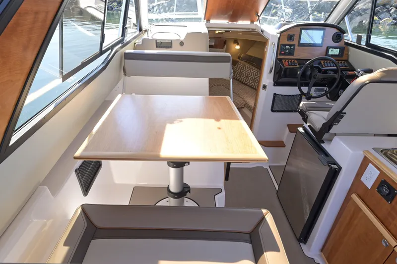 Cancelled Yacht Photos Pics 2024 Cutwater C-248 Coupe interior with dining area, helm, and cabin view.