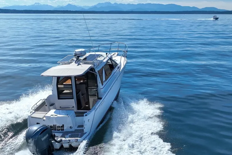 Cancelled Yacht Photos Pics 2024 Cutwater C-248 Coupe cruising on open water with scenic mountain backdrop.