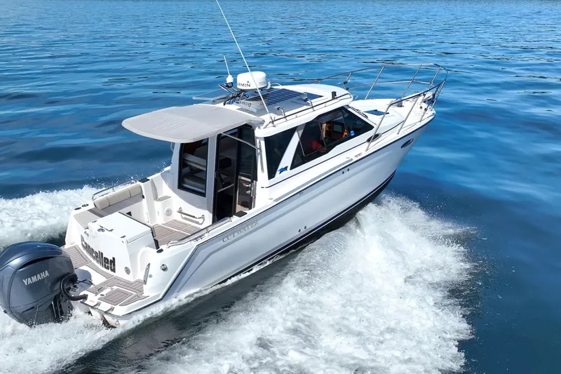 Cancelled Yacht Photos Pics 2024 Cutwater C-248 Coupe cruising on open water, showcasing sleek design and Yamaha engine.
