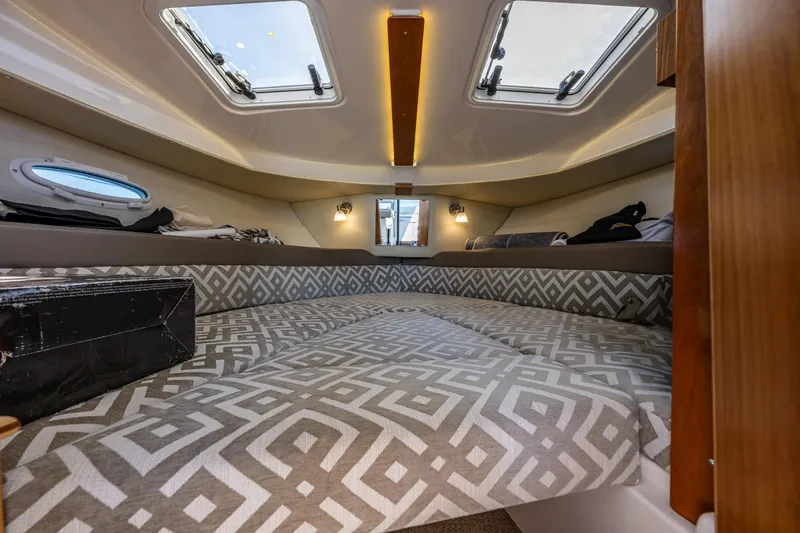 Cancelled Yacht Photos Pics 2024 Cutwater C-248 Coupe interior cabin with patterned bedding and skylights.