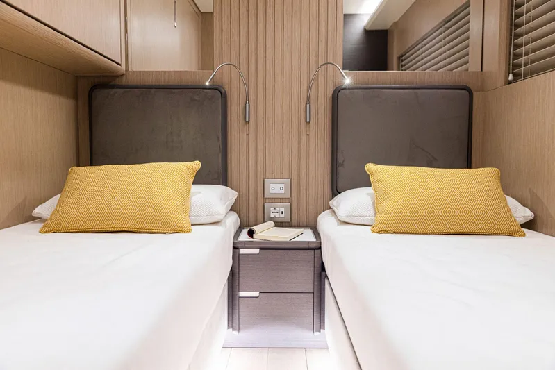  Yacht Photos Pics Twin beds in the 2024 Rizzardi GR SESSANTATRE yacht cabin with yellow pillows.