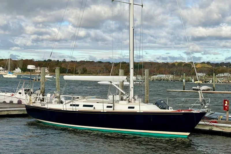 Kittywake Yacht Photos Pics 1996 J Boats J/42 sailboat docked at a marina under cloudy skies.