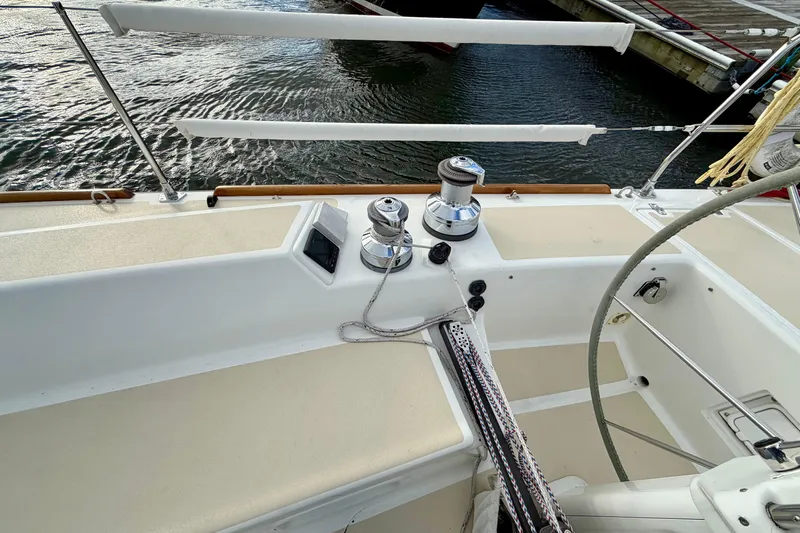 Kittywake Yacht Photos Pics 1996 J Boats J/42 sailboat cockpit with winches and ropes, docked by the water.