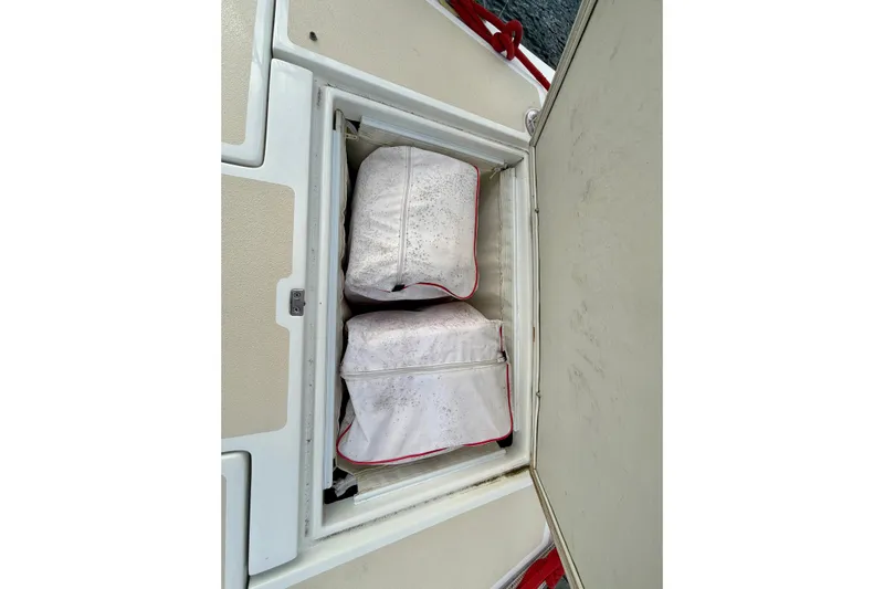Kittywake Yacht Photos Pics Storage compartment on a 1996 J Boats J/42 sailboat with two white bags inside.