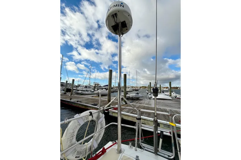 Kittywake Yacht Photos Pics 1996 J Boats J/42 sailboat docked, featuring Garmin equipment and a life ring, under a partly cloudy sky.