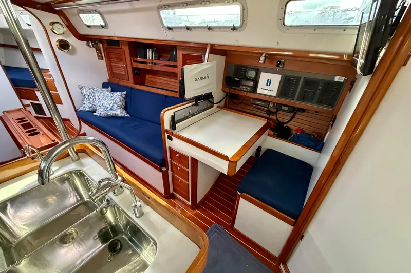 Kittywake Yacht Photos Pics Interior of 1996 J Boats J/42 sailboat with navigation station and seating area.