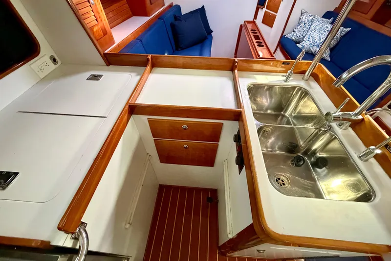 Kittywake Yacht Photos Pics 1996 J Boats J/42 yacht interior with dual sinks and wooden cabinetry.