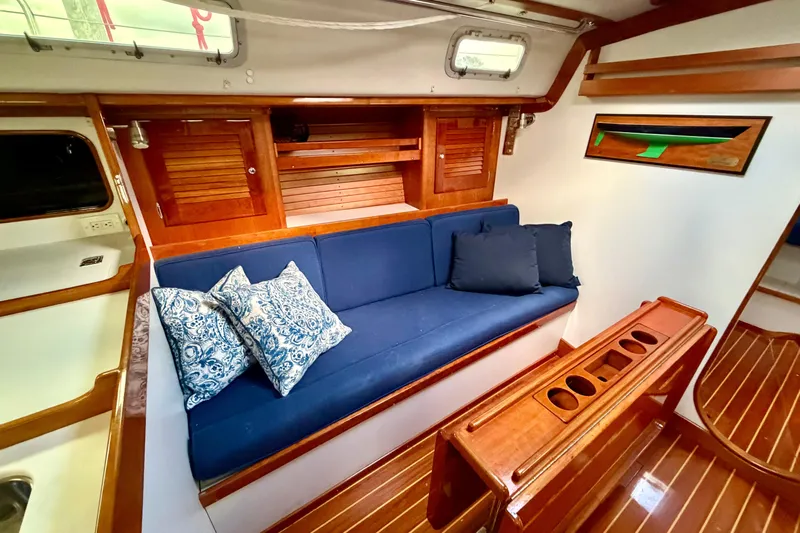 Kittywake Yacht Photos Pics Interior of 1996 J Boats J/42 sailboat with blue seating and wooden accents.
