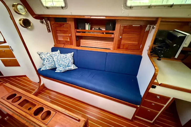 Kittywake Yacht Photos Pics Interior of 1996 J Boats J/42 sailboat with blue cushions and wooden cabinetry.