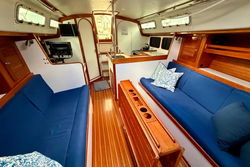Kittywake Yacht Photos Pics Interior of 1996 J Boats J/42 sailboat with blue seating and wooden finishes.