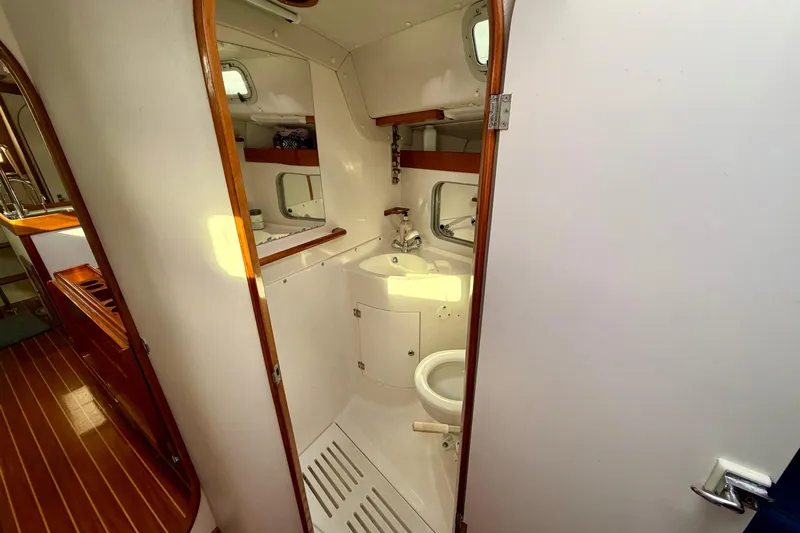 Kittywake Yacht Photos Pics 1996 J Boats J/42 yacht bathroom with sink, toilet, and wooden accents.