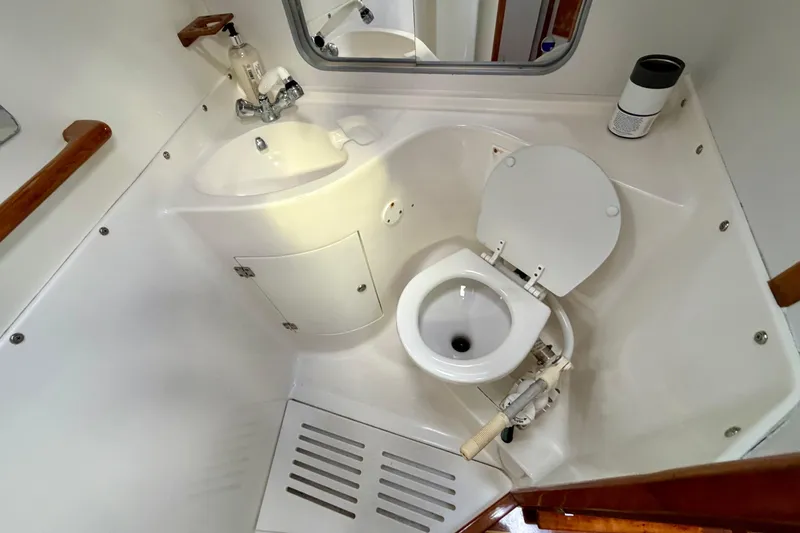 Kittywake Yacht Photos Pics 1996 J Boats J/42 yacht bathroom with sink, toilet, and mirror.