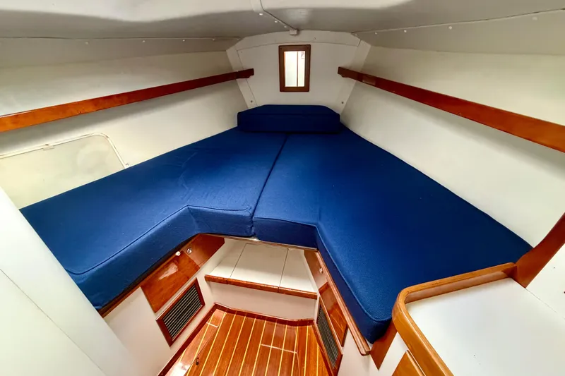 Kittywake Yacht Photos Pics Interior cabin of 1996 J Boats J/42 with blue cushions and wooden accents.