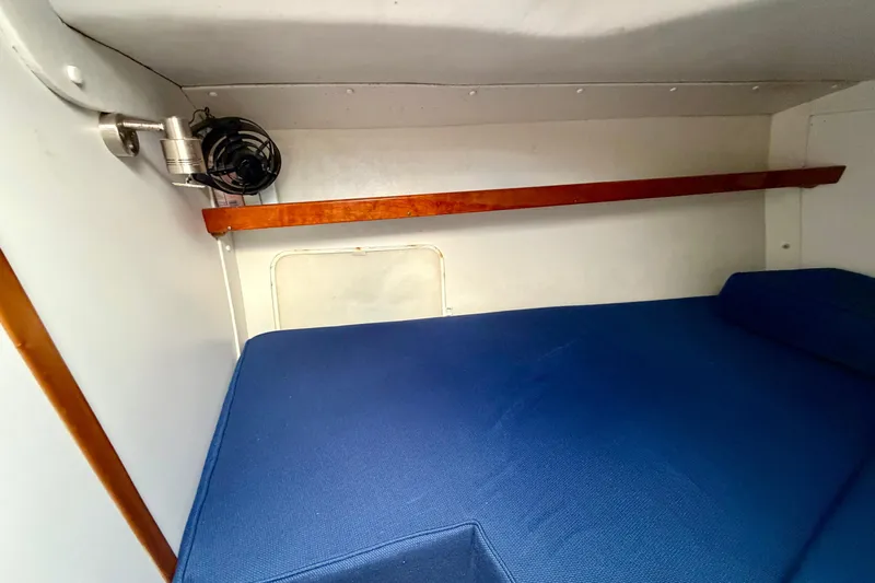 Kittywake Yacht Photos Pics Cozy cabin interior of 1996 J Boats J/42 with blue bedding and wooden accents.