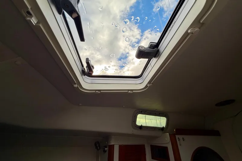 Kittywake Yacht Photos Pics Interior view of 1996 J Boats J/42 yacht, showing a skylight with raindrops.