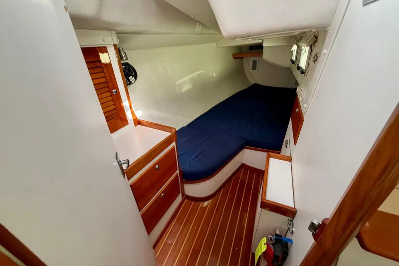 Kittywake Yacht Photos Pics 1996 J Boats J/42 cabin interior with wooden flooring and blue bedding.