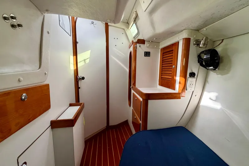 Kittywake Yacht Photos Pics Interior of 1996 J Boats J/42 sailboat with wooden cabinetry and blue seating.